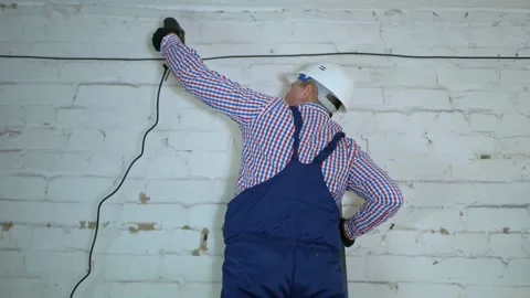 Construction of a fiber optic communication line along the wall. Stock Footage 150634136