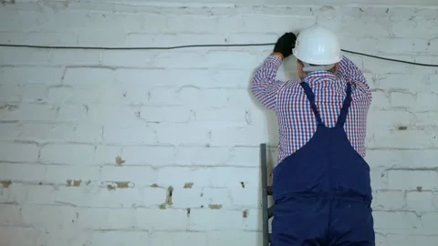 Construction of a fiber optic communication line along the wall. Stock Footage 150653031