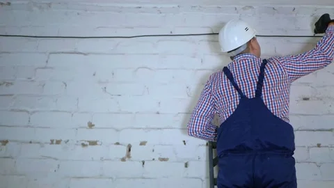 Construction of a fiber optic communication line along the wall. Stock Footage 150653091