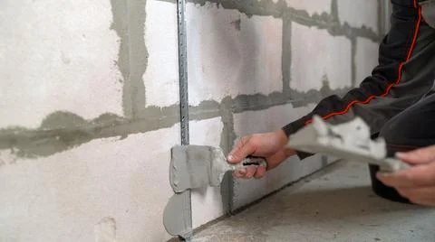 Construction. Fixing building beacons to the wall. Fastening building beacons Stock Photos