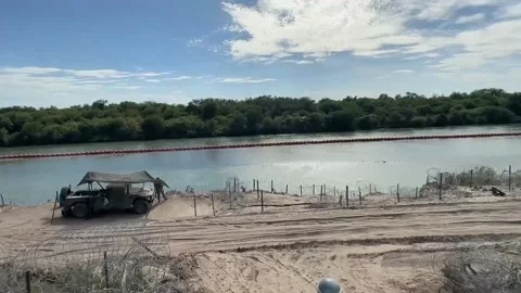 Construction of "floating wall" made of spiked buoys advances in Texas, Eagle Pa Stock Footage 247095547