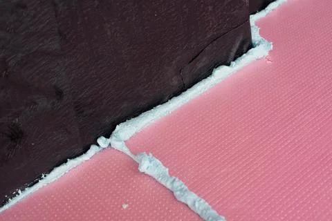 Construction foam between pink extruded styrofoam sheets Stock Photos