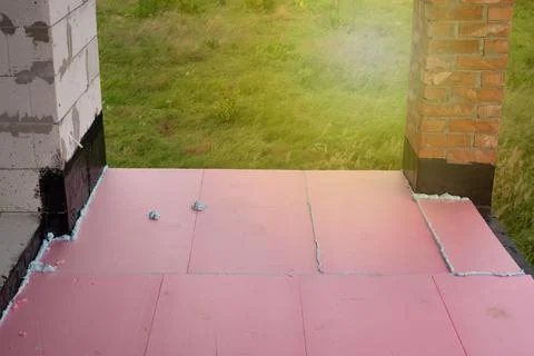 Construction foam between pink extruded styrofoam sheets Foto stock