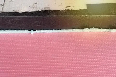 Construction foam between pink extruded styrofoam sheets Stock Photos