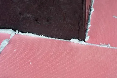 Construction foam between pink extruded styrofoam sheets Foto stock