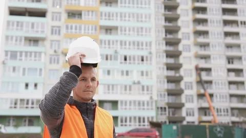 Construction foreman clothes a white helmet at a construction site Stock Footage 117989322