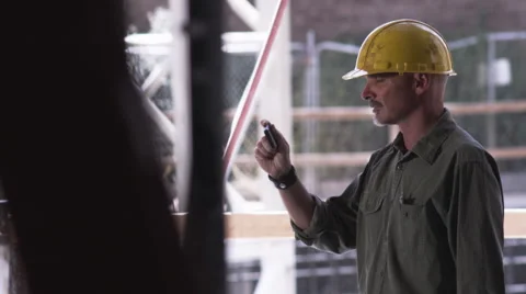 Construction Foreman on phone tilt up Stock Footage 62886890