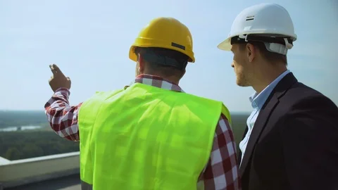 Construction foreman talking to contractor discussing project details outdoors Stock-Footage 117212735