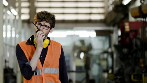 Construction foreman working on walkie-talkie talking in industrial factory. Stock Footage 157275965