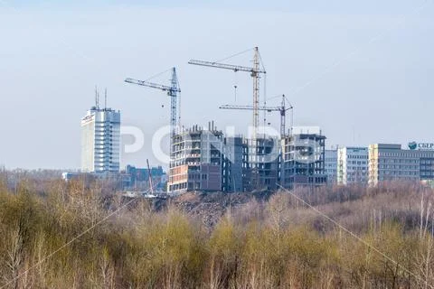 Construction of a frame building with three tower cranes. The new ...