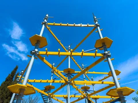 Construction framework stands tall against the blue sky in a building area .. Photos