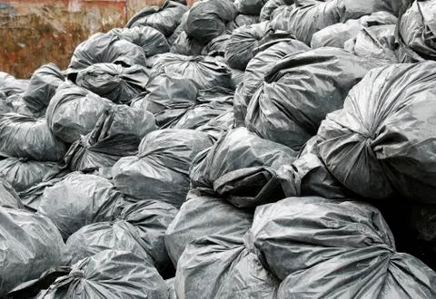 Construction garbage bags in dumpster Stock Photos