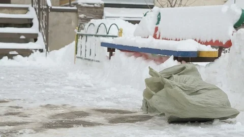 Construction garbage in bags lying in the snow 動画素材 81259466