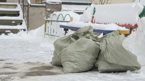 Construction garbage in bags lying in the snow 動画素材 81309399