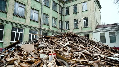 Construction garbage is piled up at site after building repair. Trash heap. Видео 237712847
