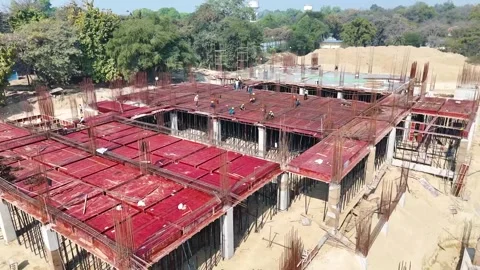 Construction going on with unfinished projects with people working on them Stock Footage 299825424