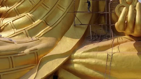 Construction of gold Buddha towering over urban Thailand skyline Stock Footage 306759137