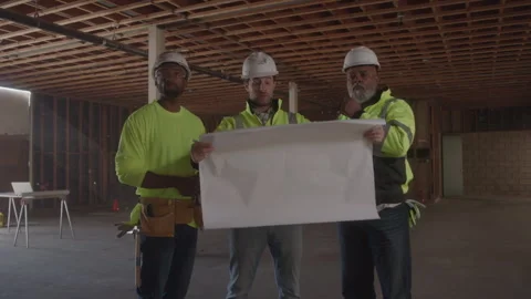 Construction Guys Looking At Blueprints Together On Job Site Stock Footage 270389074