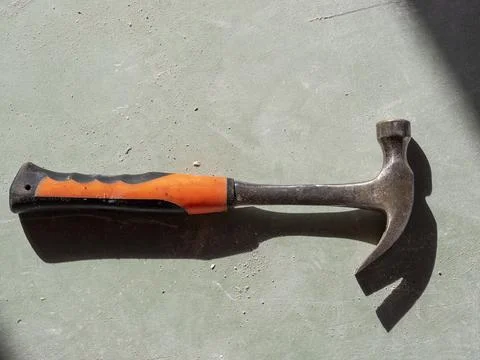 Construction hammer on drywall. the view from the top, hard shadows. Tools fo Stock Photos
