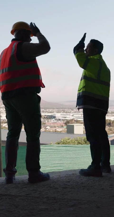 Construction, happy or men on site with high five, team success or motivation in Stock Footage 336264638