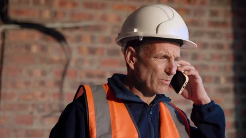 Construction, hardhat and phone call with man on worksite for planning or Stock Footage 336205559