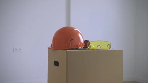 Construction Helmet and Glasses on Moving Box Stock Footage 313349517