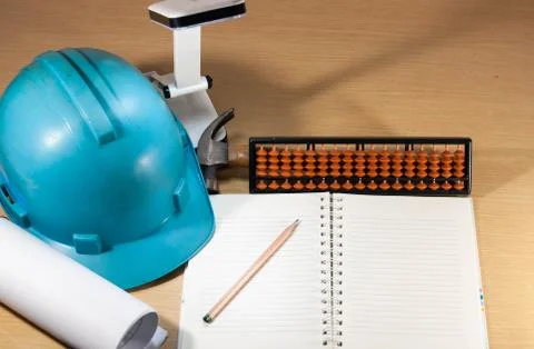 Construction helmet, calculating, working anytime, anywhere Stock Photos