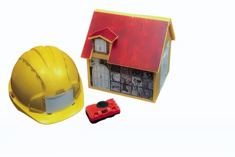 Construction helmet, laser level, and model house illustrating home renovat.. Stock Photos