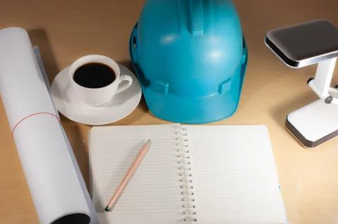 Construction helmets, coffee, desk top anytime, anywhere. Stock Photos