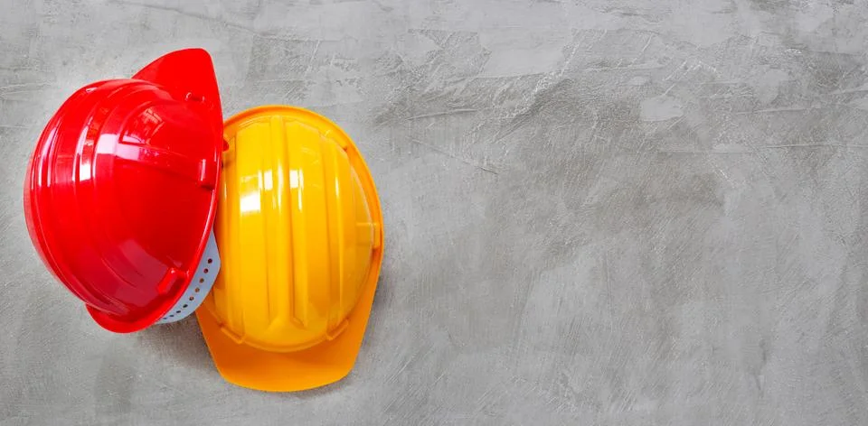 Construction helmets on concrete background. Stock Photos