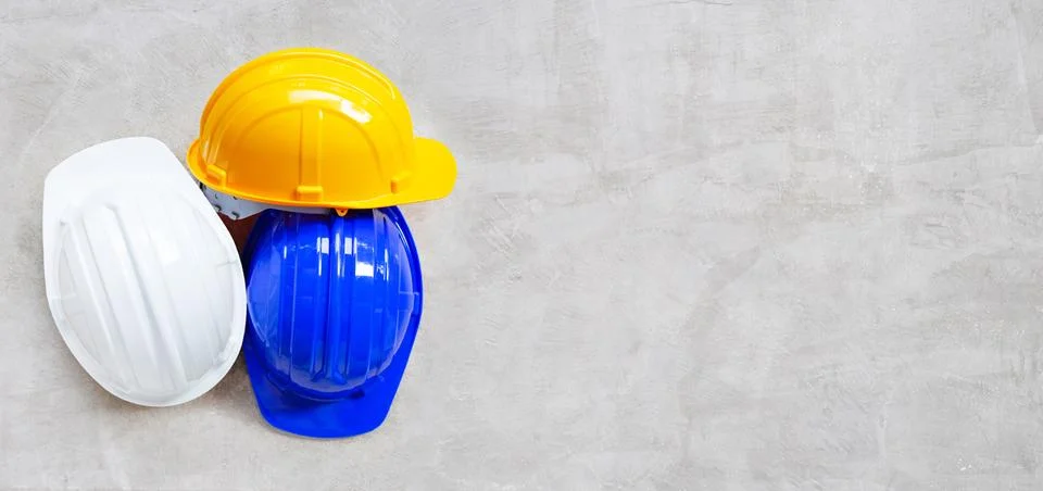Construction helmets on concrete background. Stock Photos