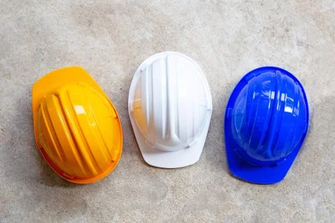 Construction helmets on concrete background. Stock Photos