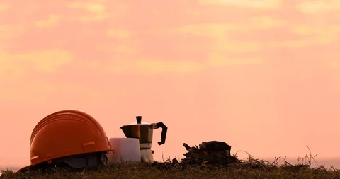 Construction helmets with mocha pots, coffee cups, bonfires, Stock Footage 120081052