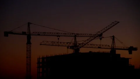 Construction of high-rise building against on the background of sunrise, time la Stock Footage 90381945