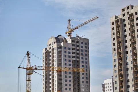 Construction of a high-rise building area using tower cranes. 库存照片