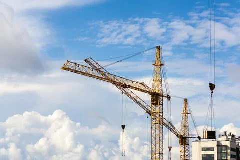 Construction of a high-rise building with a crane. The construction crane and Stock Photos