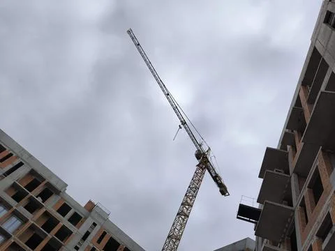 Construction of a high-rise building, a crane against a backdrop of clouds 写真素材