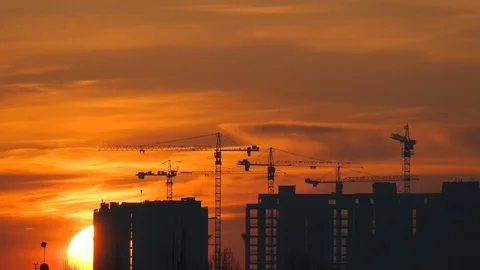 Construction of a high-rise building on a sunset background Stock-Footage 121010347
