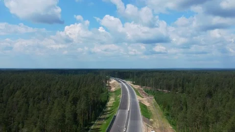 Construction of a high speed highway in the forest. Aerial video from drone Stock Footage 142908854