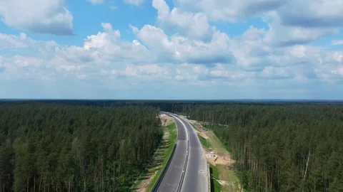 Construction of a high speed highway in the forest. Aerial video from drone Stock Footage 142981853
