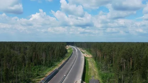 Construction of a high speed highway in the forest. Aerial video from drone Stock Footage 144233779