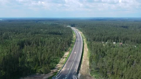 Construction of a high speed highway in the forest. Aerial video from drone Stock Footage 144312929