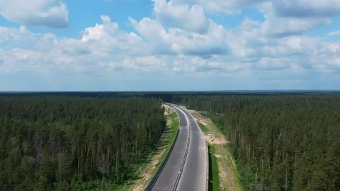 Construction of a high speed highway in the forest. Aerial video from drone Vídeos de archivo 144358324