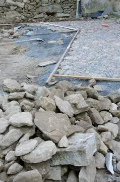 Construction of historic looking cobblestone pavement on the yard Stock Photos