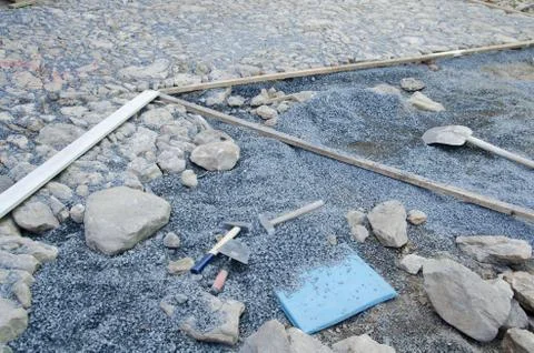 Construction of historic looking cobblestone pavement on the yard Stock Photos