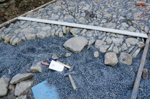 Construction of historic looking cobblestone pavement on the yard Stock Photos