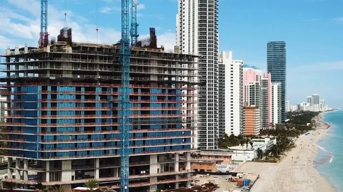 Construction of hotel with glassy walls on the background of blue sky and modern Stock Footage 101131458