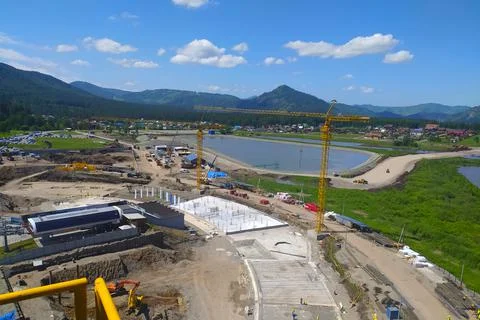 Construction of a hotel with the help of tower cranes, in the mountains against Stock Photos