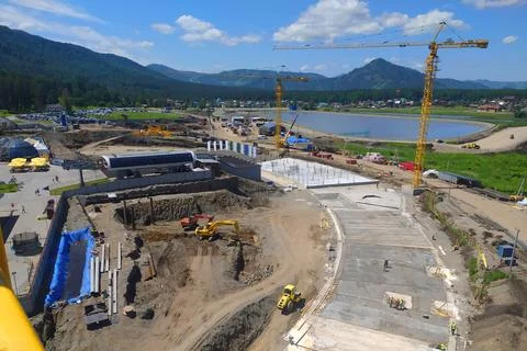 Construction of a hotel with the help of tower cranes, in the mountains against Stock Photos