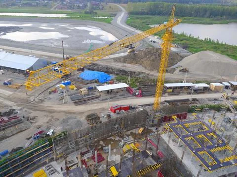 Construction of a hotel with the help of tower cranes, in the mountains against Stock Photos
